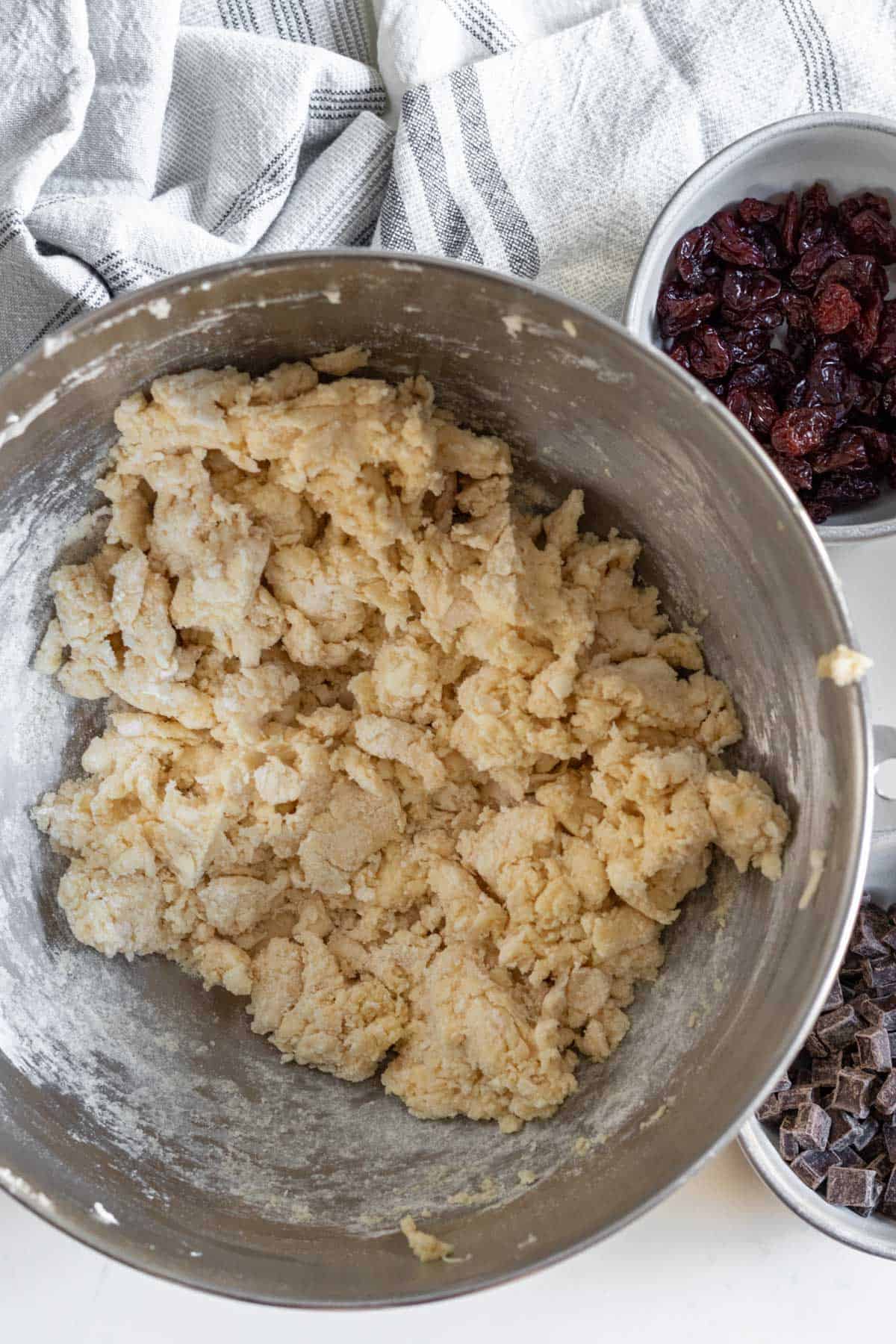 scone dough in a silver mixing bowl that has been mixed together 