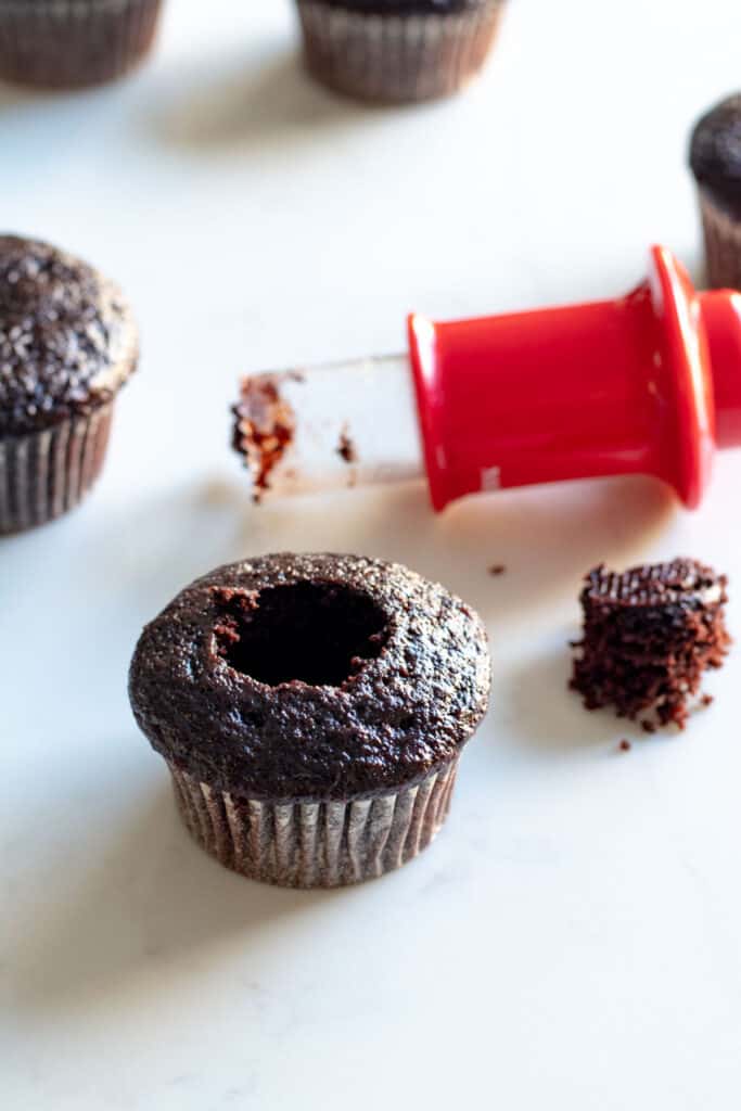 chocolate cupcake with core cut out with cupcake corer next to it