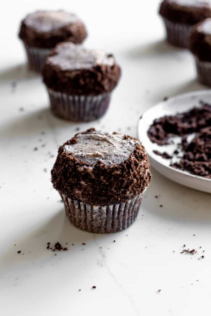 chocolate cupcake frosted with oreo buttercream with crushed oreos on sides of frosting