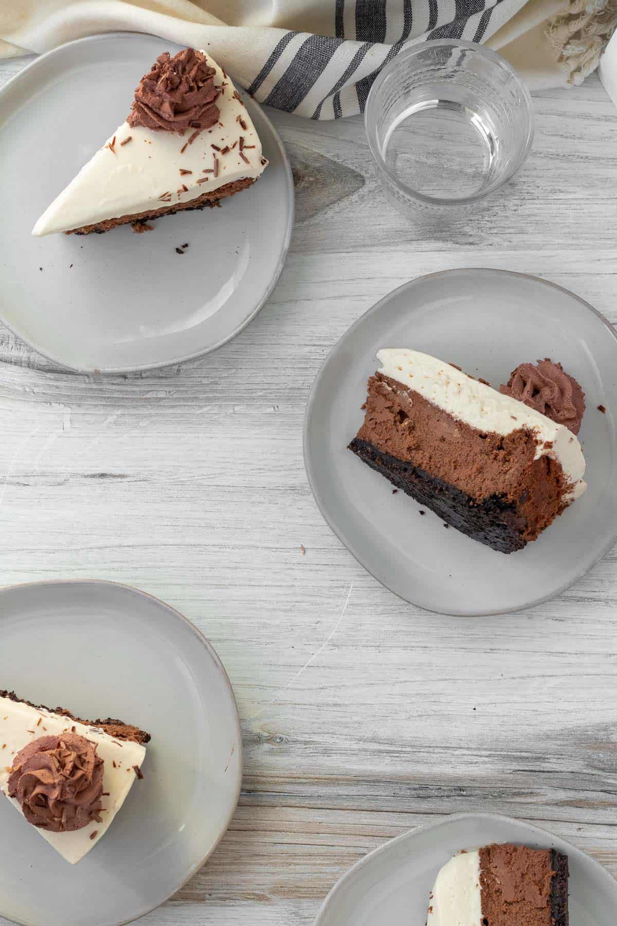 plates of individual slices of chocolate Baileys cheesecake