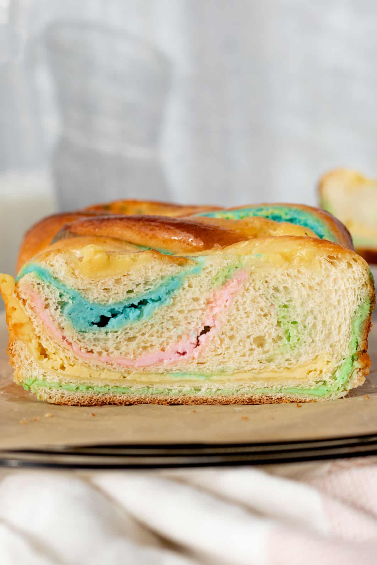 swirls of colored cream cheese in a baka loaf slice sitting on a cooling rack