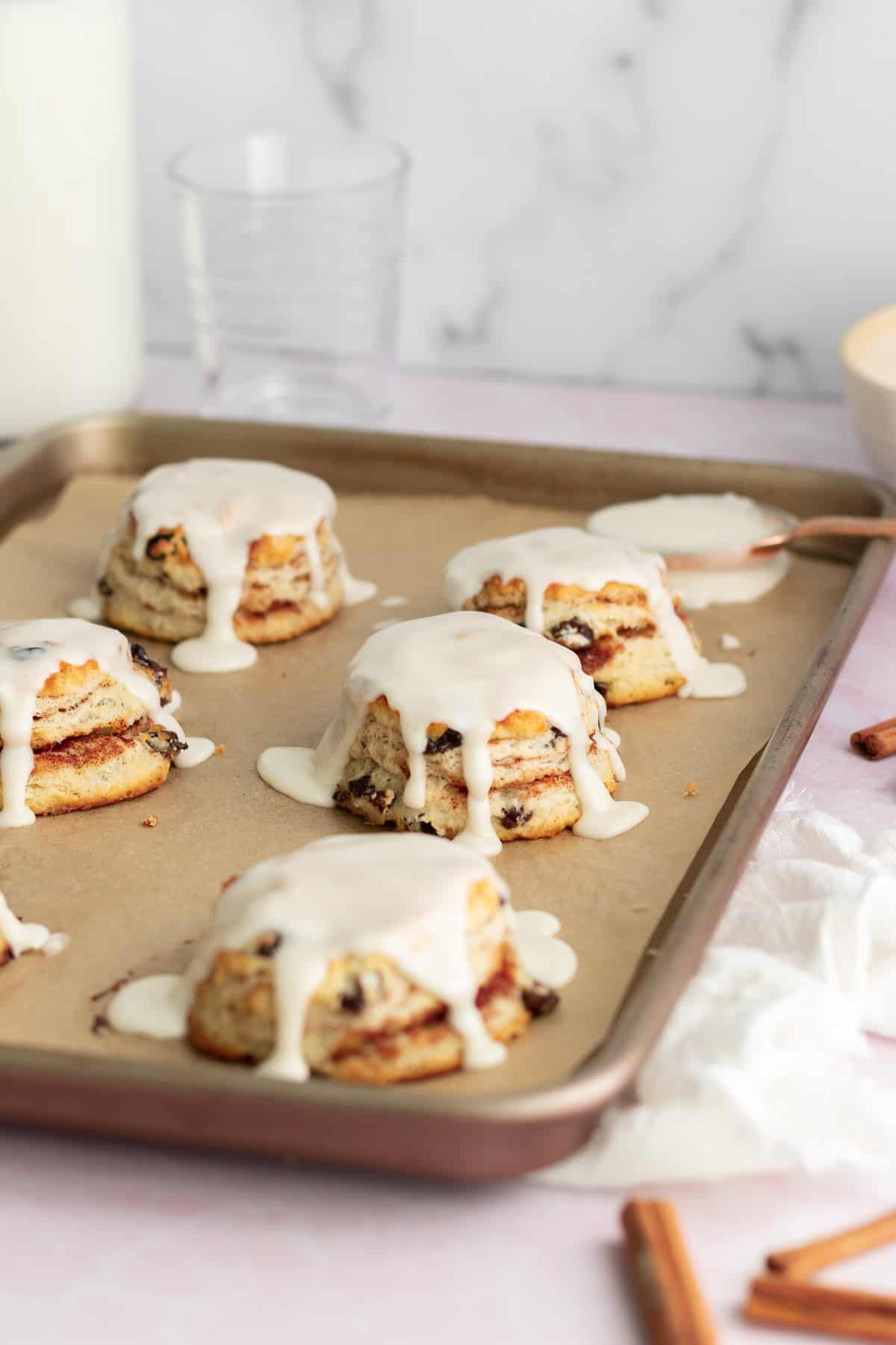 baking tray of glazed biscuits with glass of milk behind 