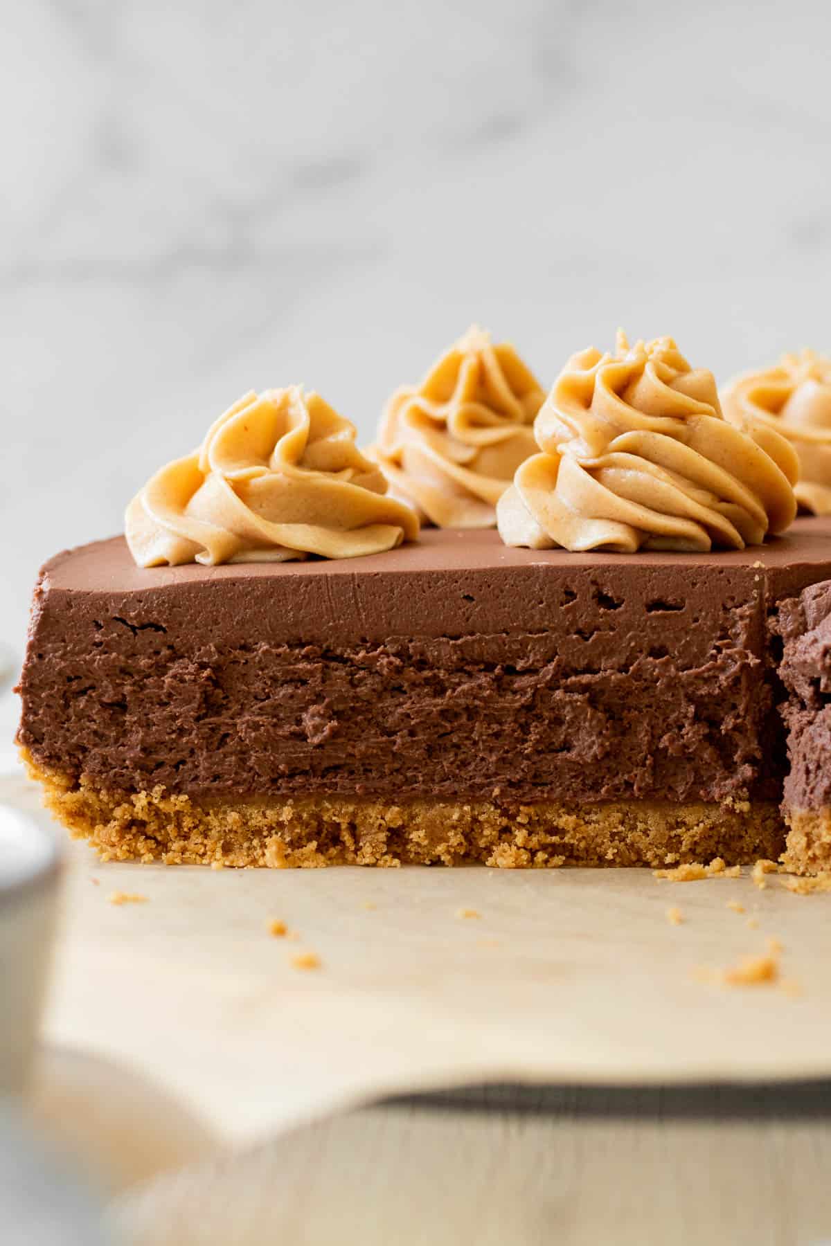 sliced chocolate cheesecake with peanut butter swirls on top