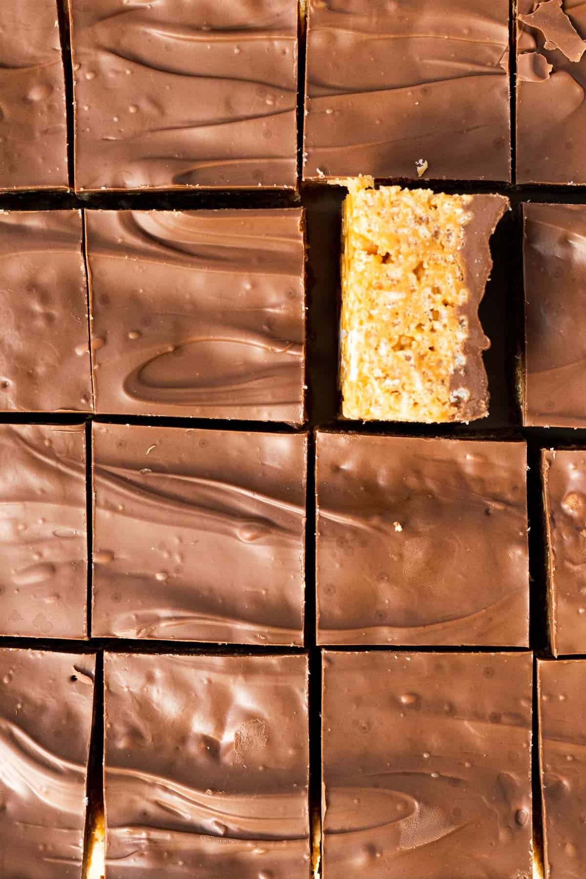 chocolate peanut butter rice krispie treats sliced into squares with the chocolate side up and one square on its side