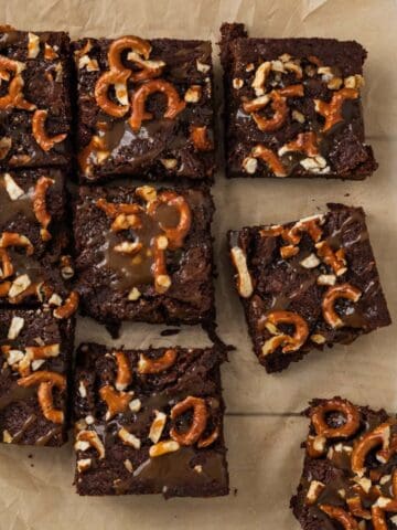 brownies topped with salted caramel and pretzels cut into squares