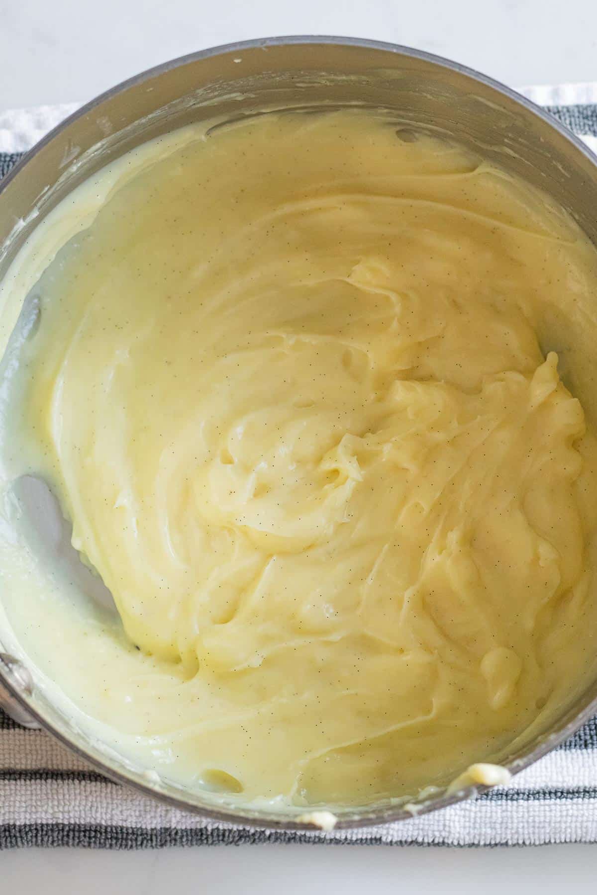 silver mixing bowl of vanilla bean pastry cream