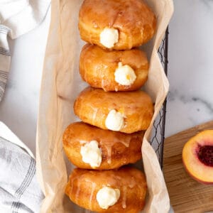 basket of peach doughnuts with cream filling