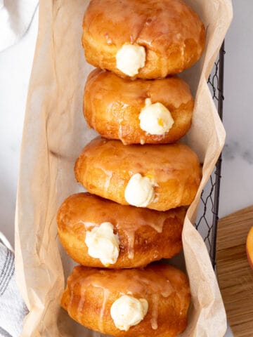 basket of peach doughnuts with cream filling