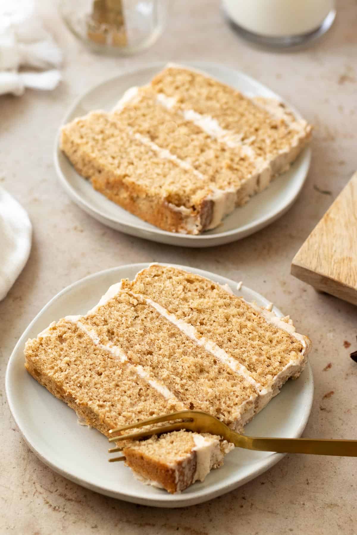 slices of chai cake on round plates with a gold fork