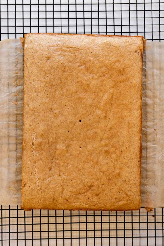 sheet cake on a wire cooling rack lined with parchment