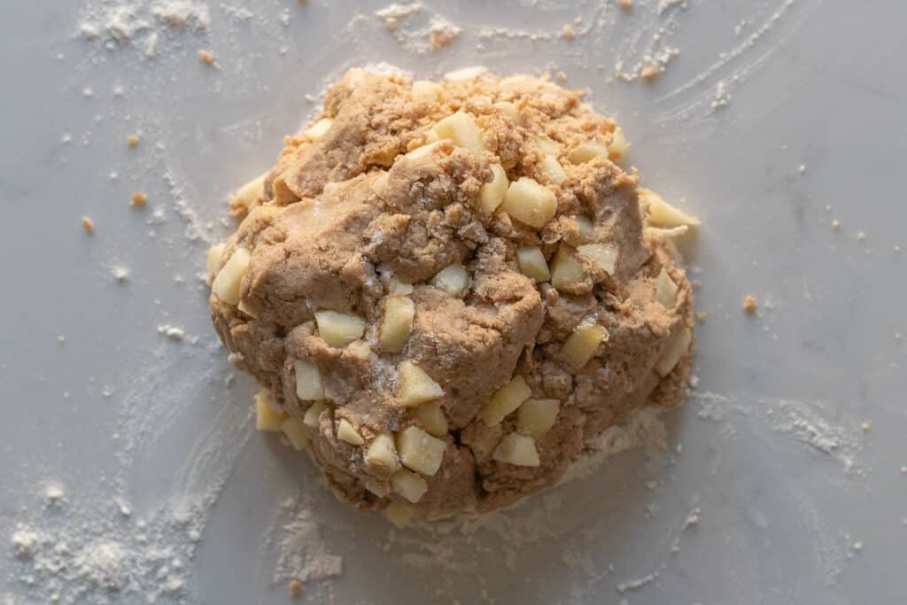 apple cinnamon scone dough sitting on a marble counter