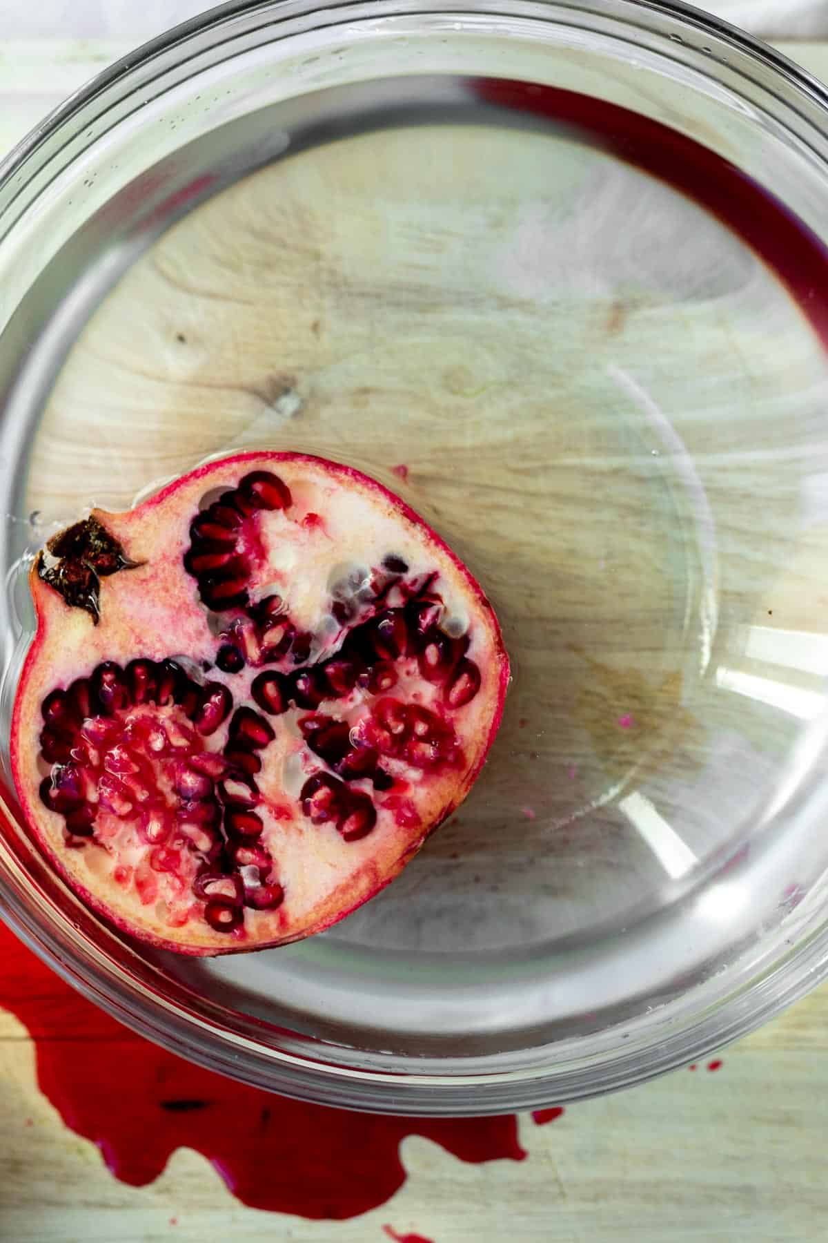 half a pomegranate submerged in water