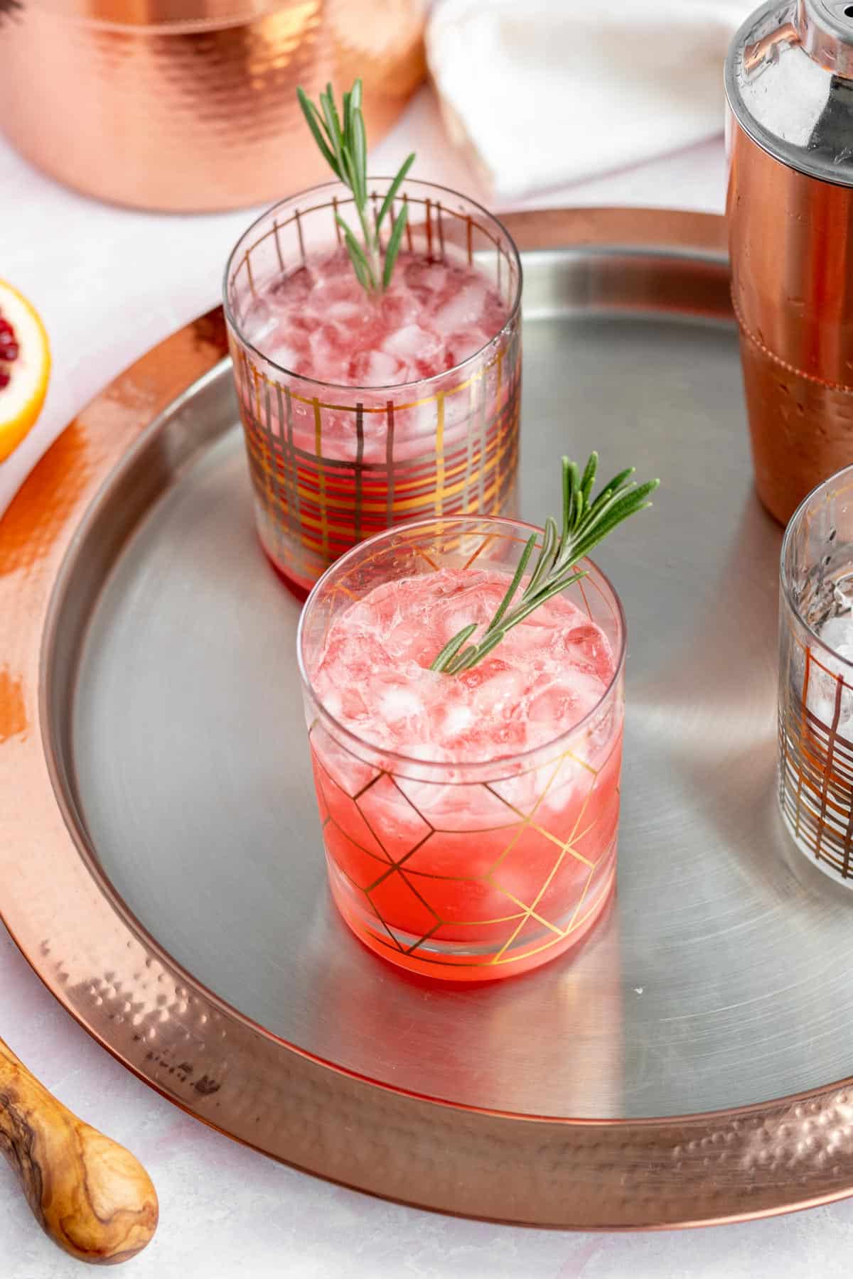 blood orange gin cocktail sitting on a gold and silver drink tray