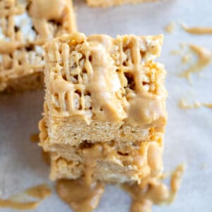 close up of a peanut butter rice krispie bar with a peanut butter drizzle
