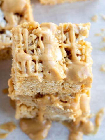 close up of a peanut butter rice krispie bar with a peanut butter drizzle
