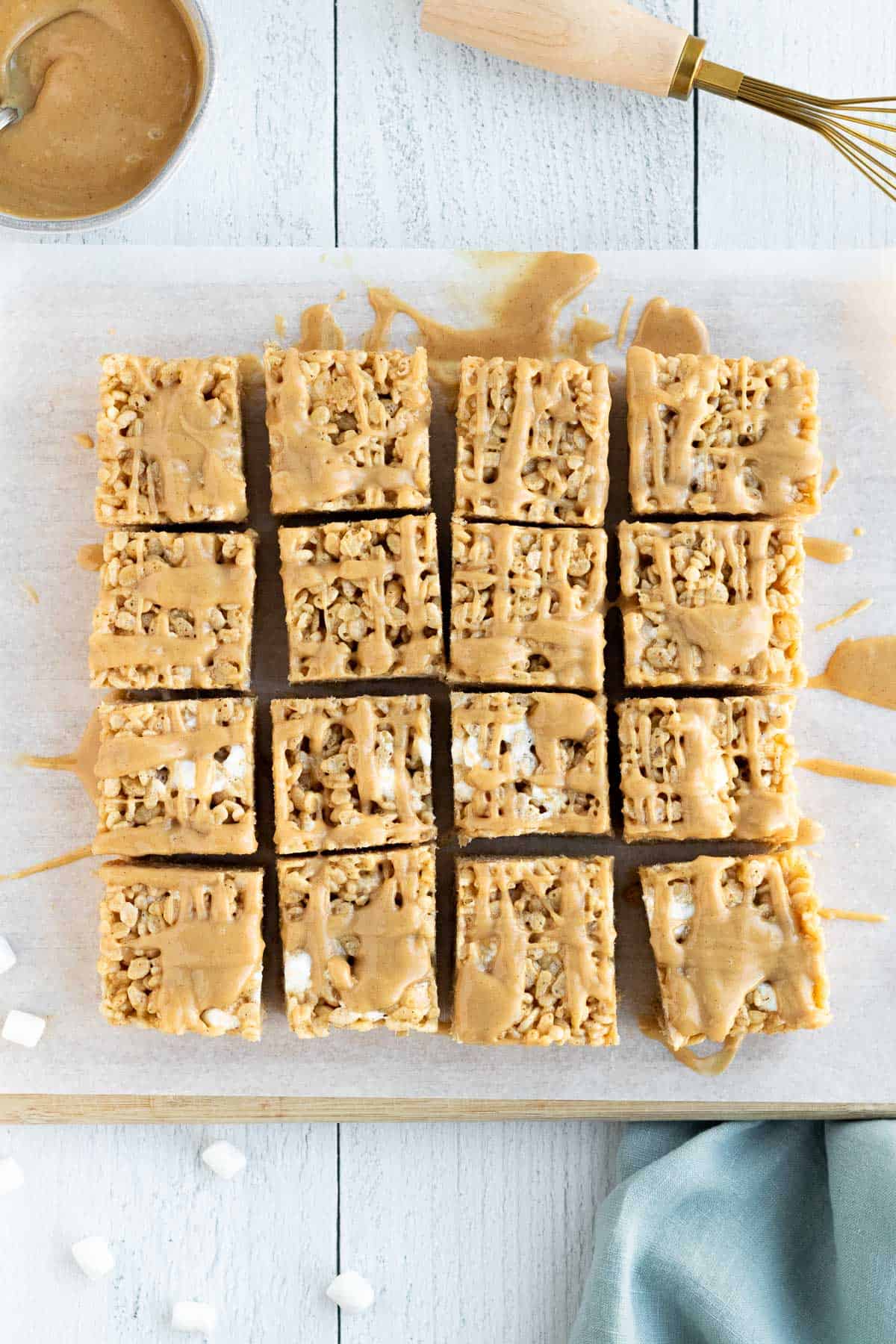 peanut butter rice krispie bars sliced into squares and sitting on a cutting board