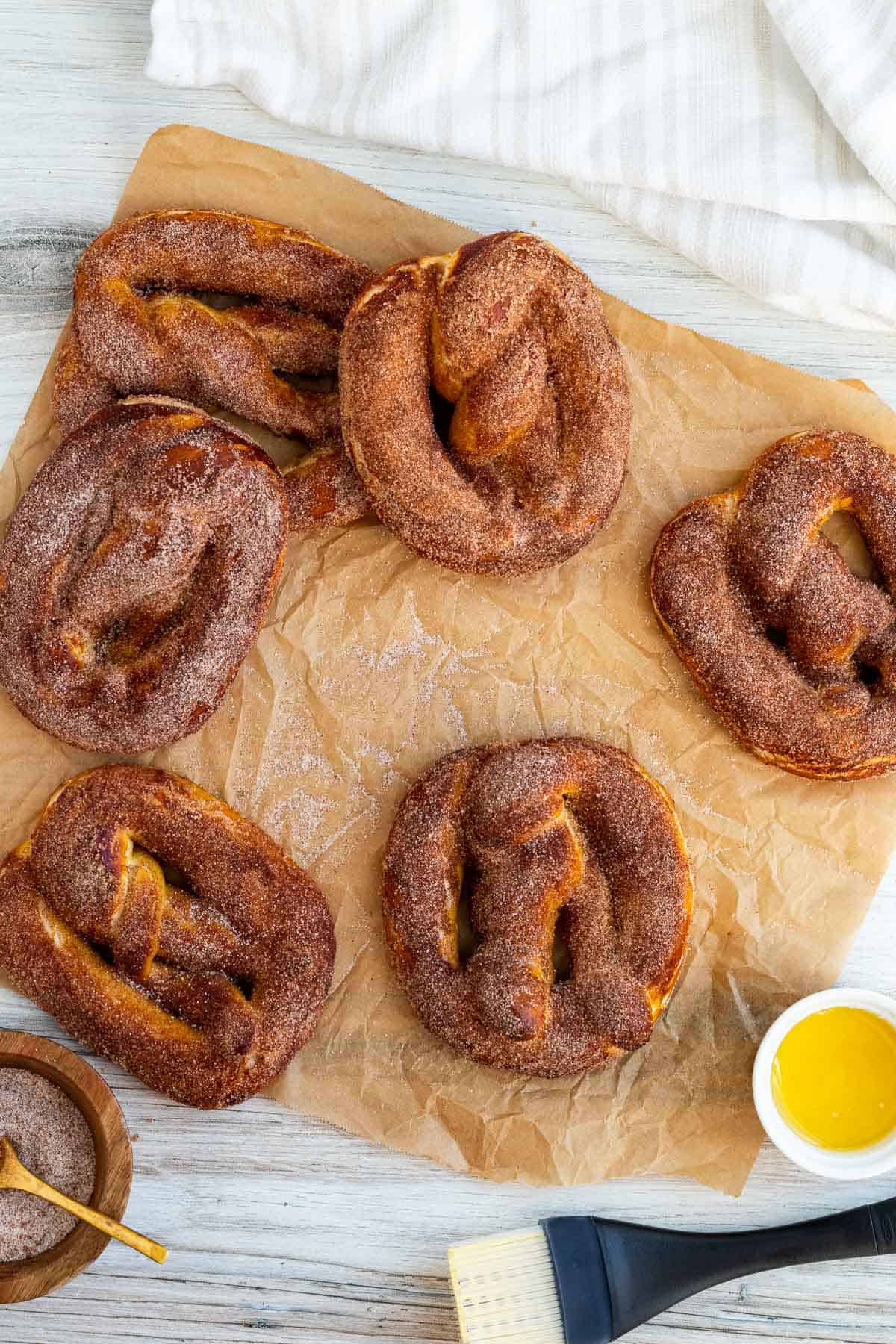 cinnamon pretzels sitting on top of parchment paper