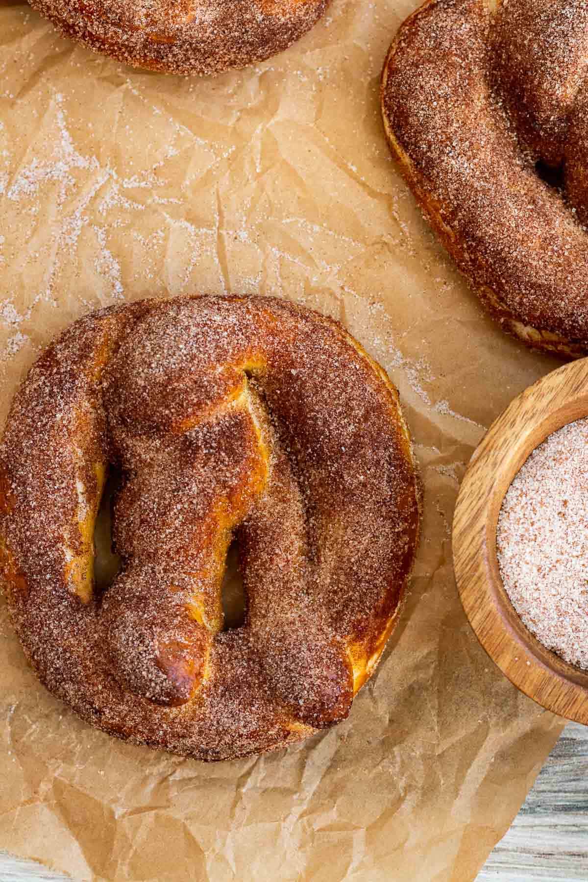 cinnamon pretzel with bowl of cinnamon sugar next to it