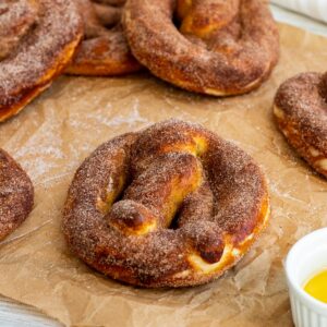 cinnamon pretzels sitting on top of parchment paper