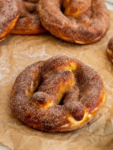 cinnamon pretzels sitting on top of parchment paper