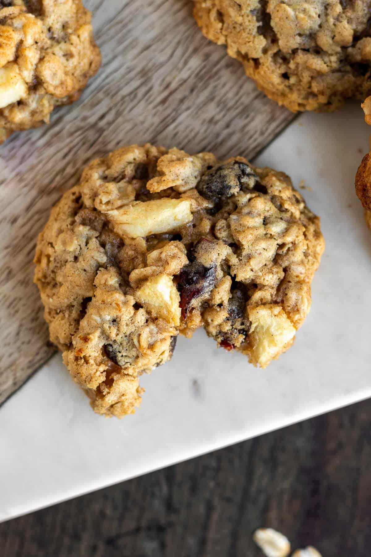 close up of an apple oatmeal cookie with a bite taken out of it