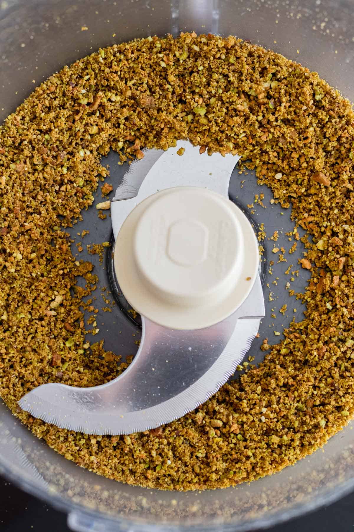 finely ground pistachios in a food processor bowl