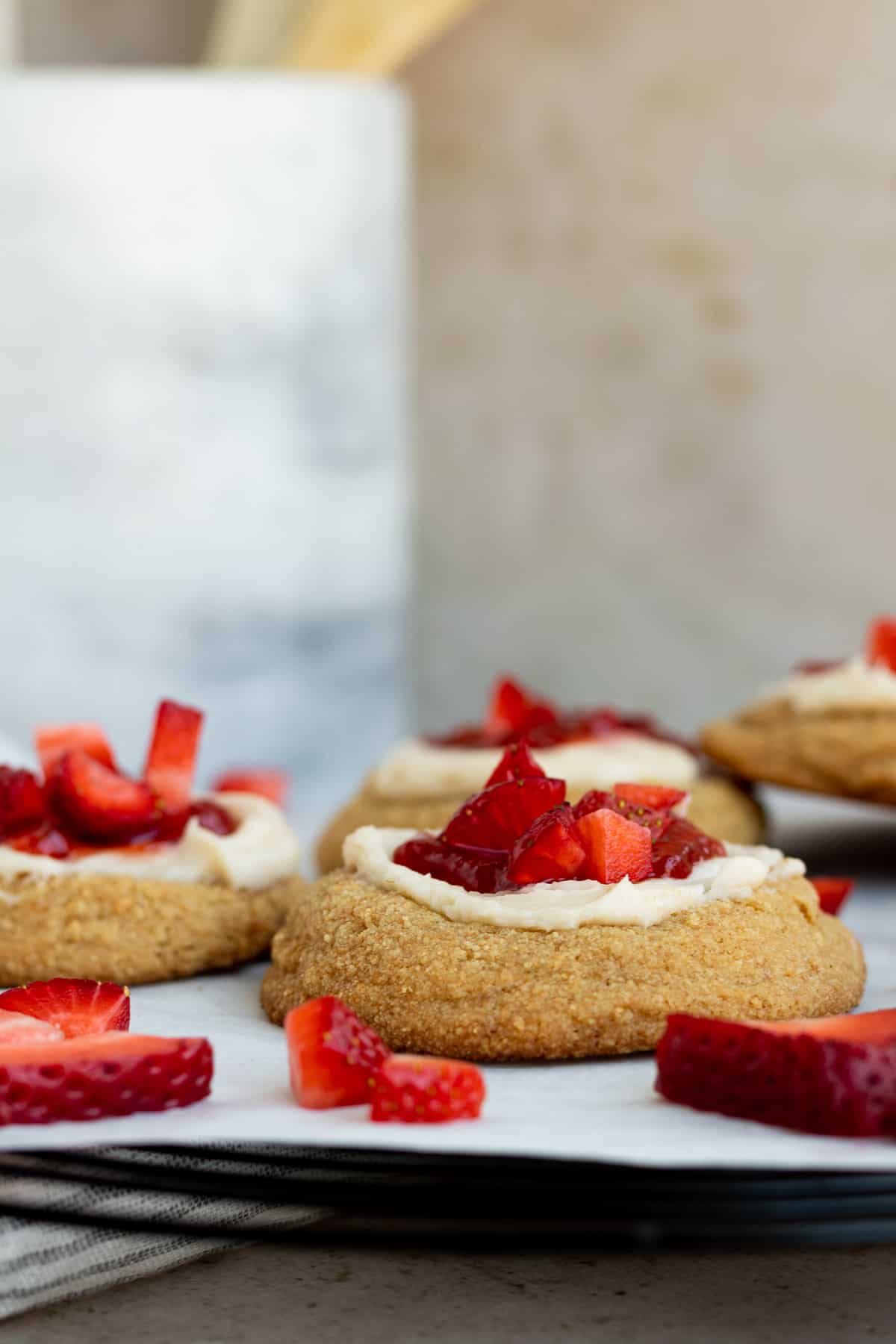 strawberry cheesecake cookies on a black cooling rack lined with parchment