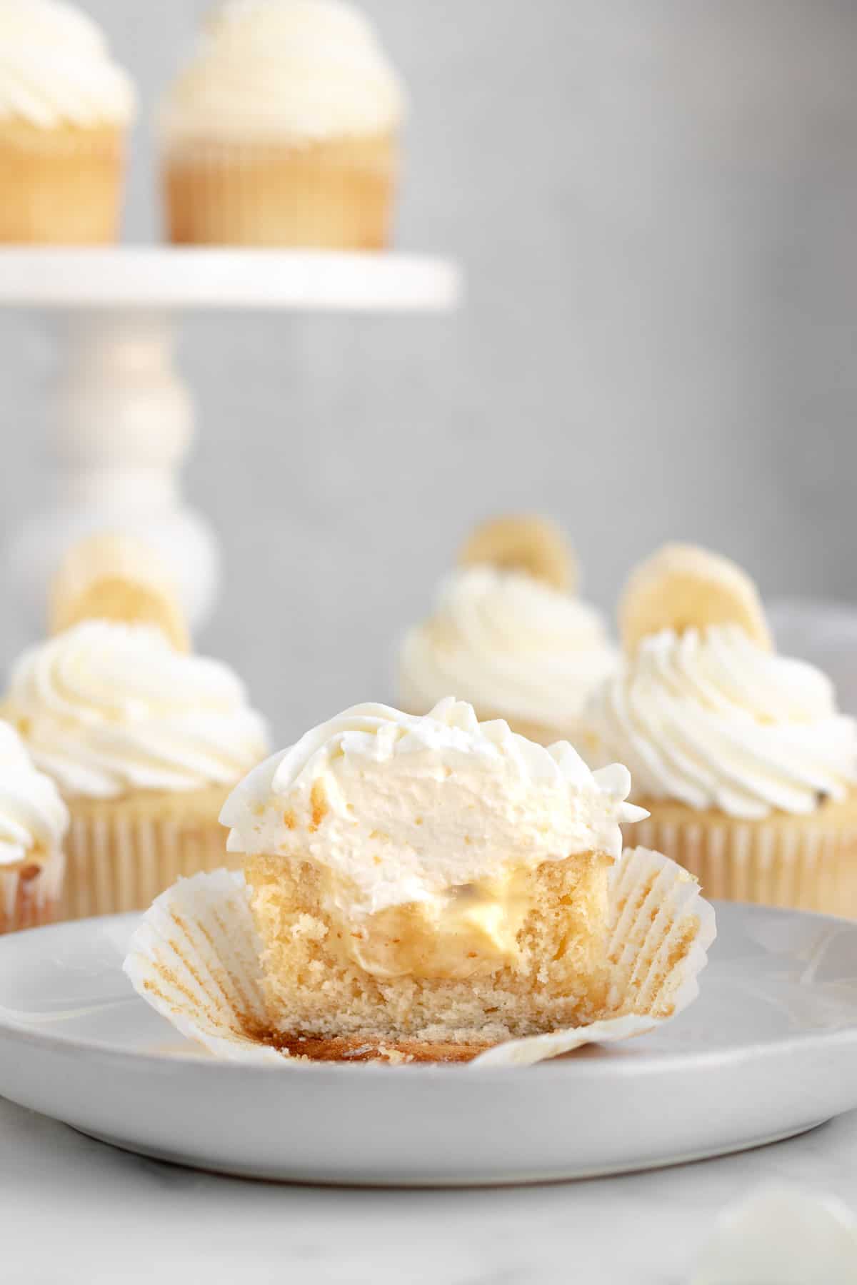 banana pudding cupcake cut in half to show banana pudding filling