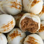 A pile of Biscoff truffles dipped in white chocolate and sprinkled with Biscoff cookie crumbs
