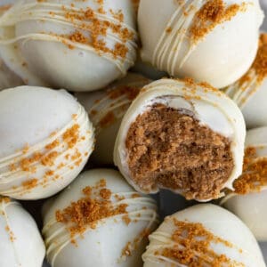 A pile of Biscoff truffles dipped in white chocolate and sprinkled with Biscoff cookie crumbs