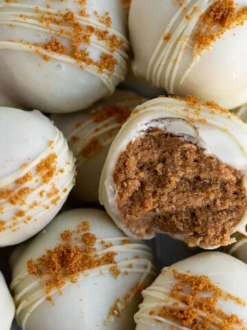 A pile of Biscoff truffles dipped in white chocolate and sprinkled with Biscoff cookie crumbs