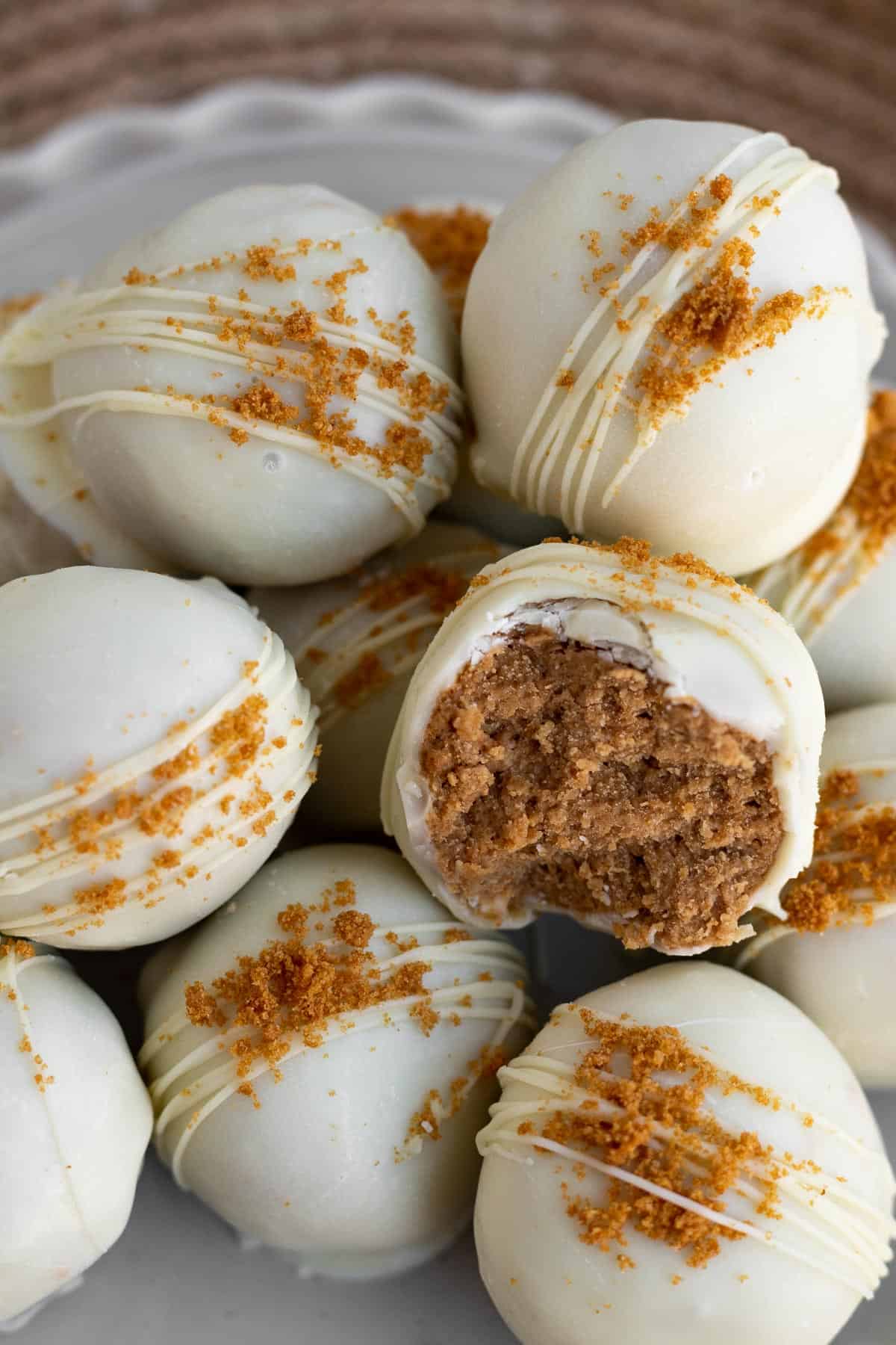 A pile of Biscoff truffles dipped in white chocolate and sprinkled with Biscoff cookie crumbs