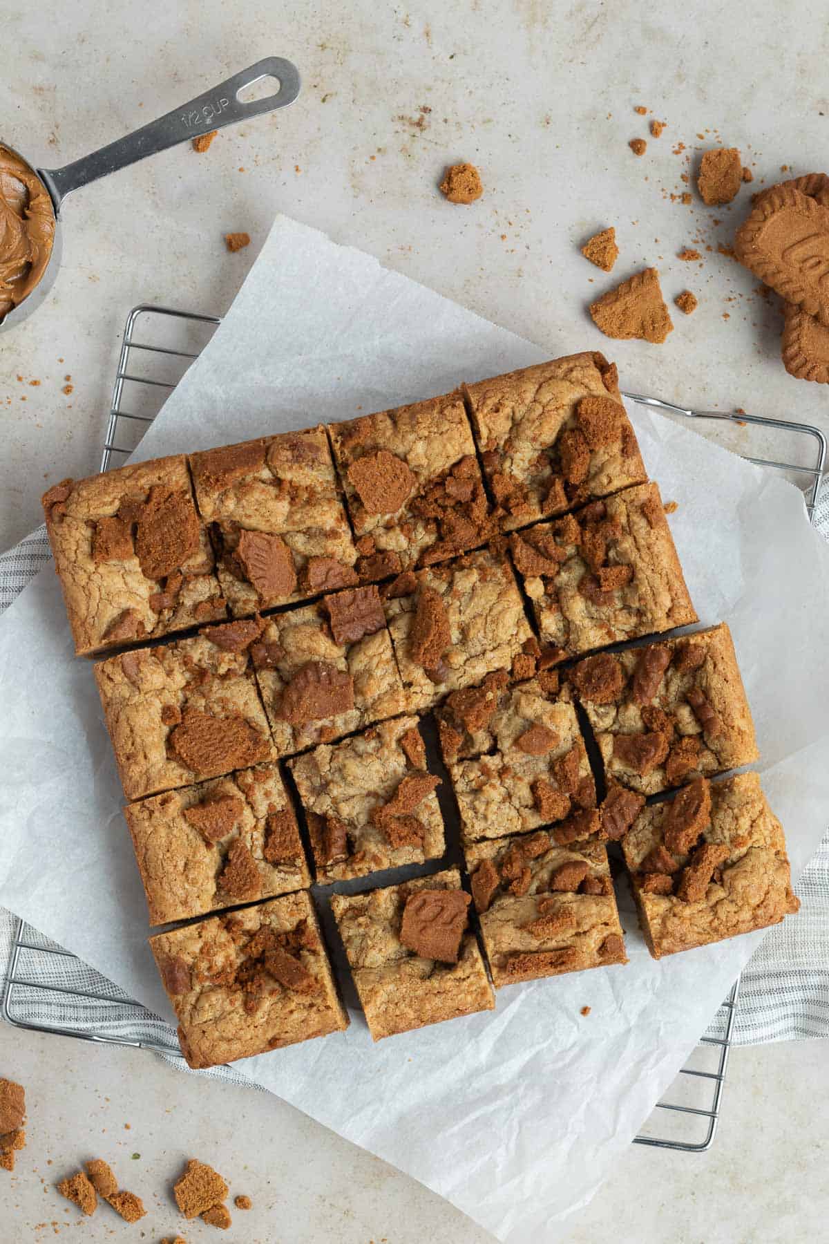 a pan of sliced biscoff blondies on a piece of parchment paper