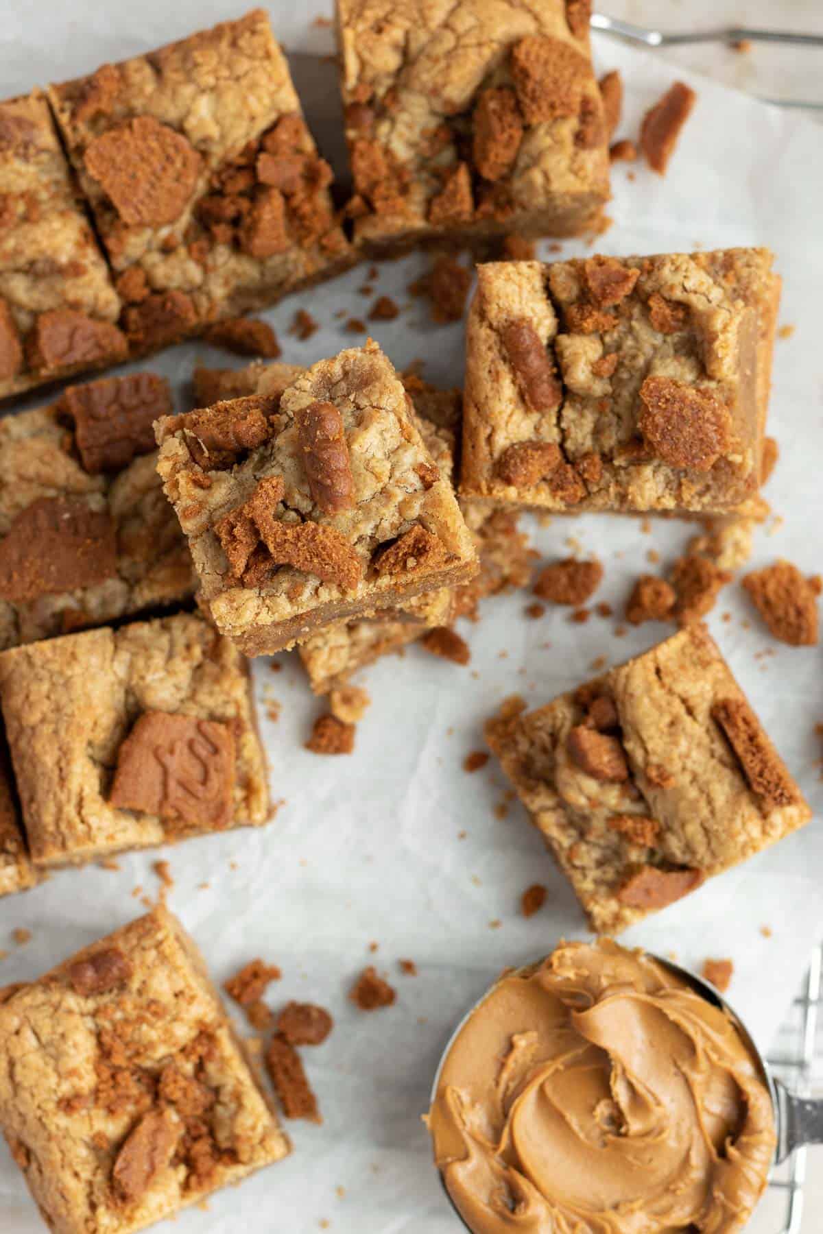 a pile of Biscoff blondies sitting on parchment paper