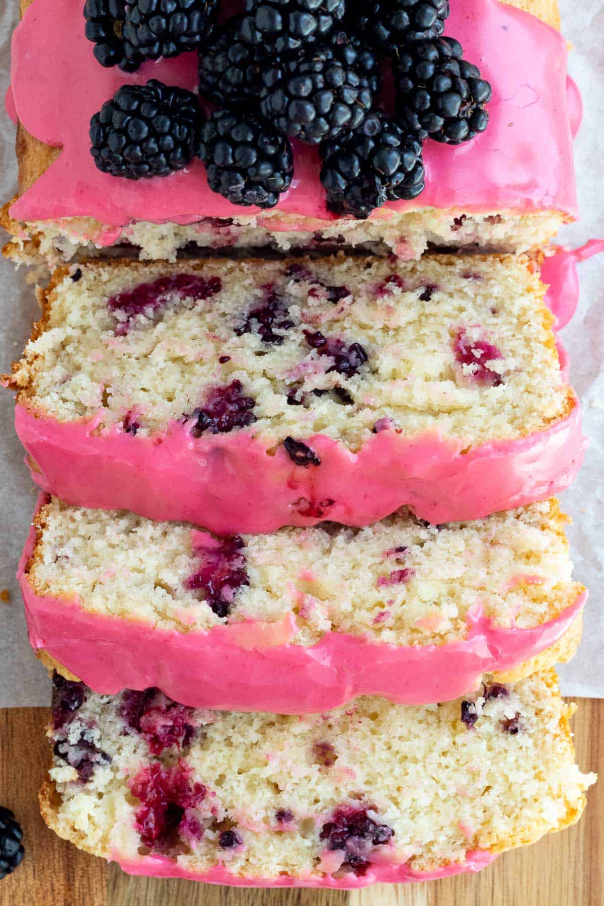 blackberry lemon bread cut into slices and stacked over one another