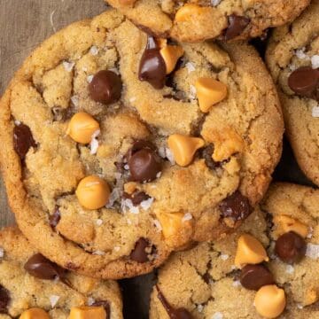 Close up of a chocolate chip butterscotch cookie with sprinkles of sea salt on top