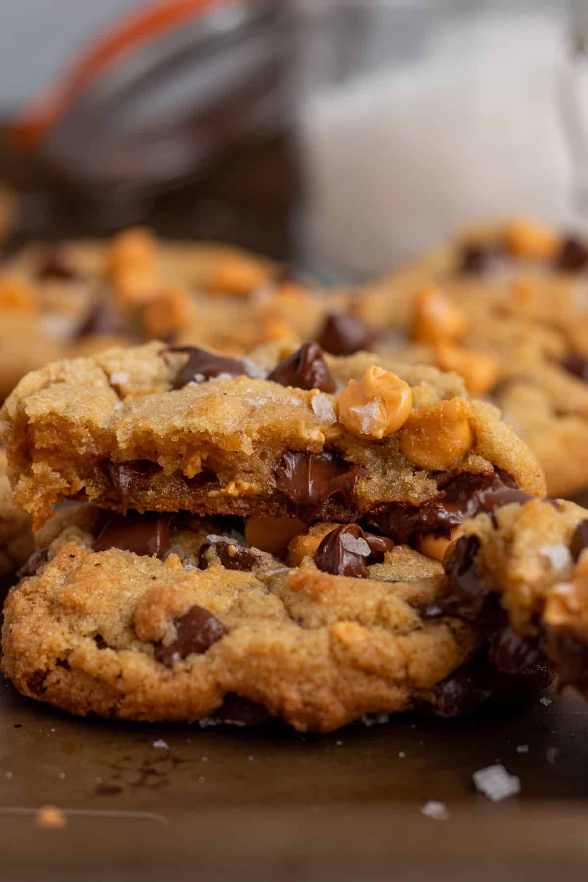 stack of  2 chocolate chip butterscotch cookies partially eaten with gooey melted chocolate and butterscotch
