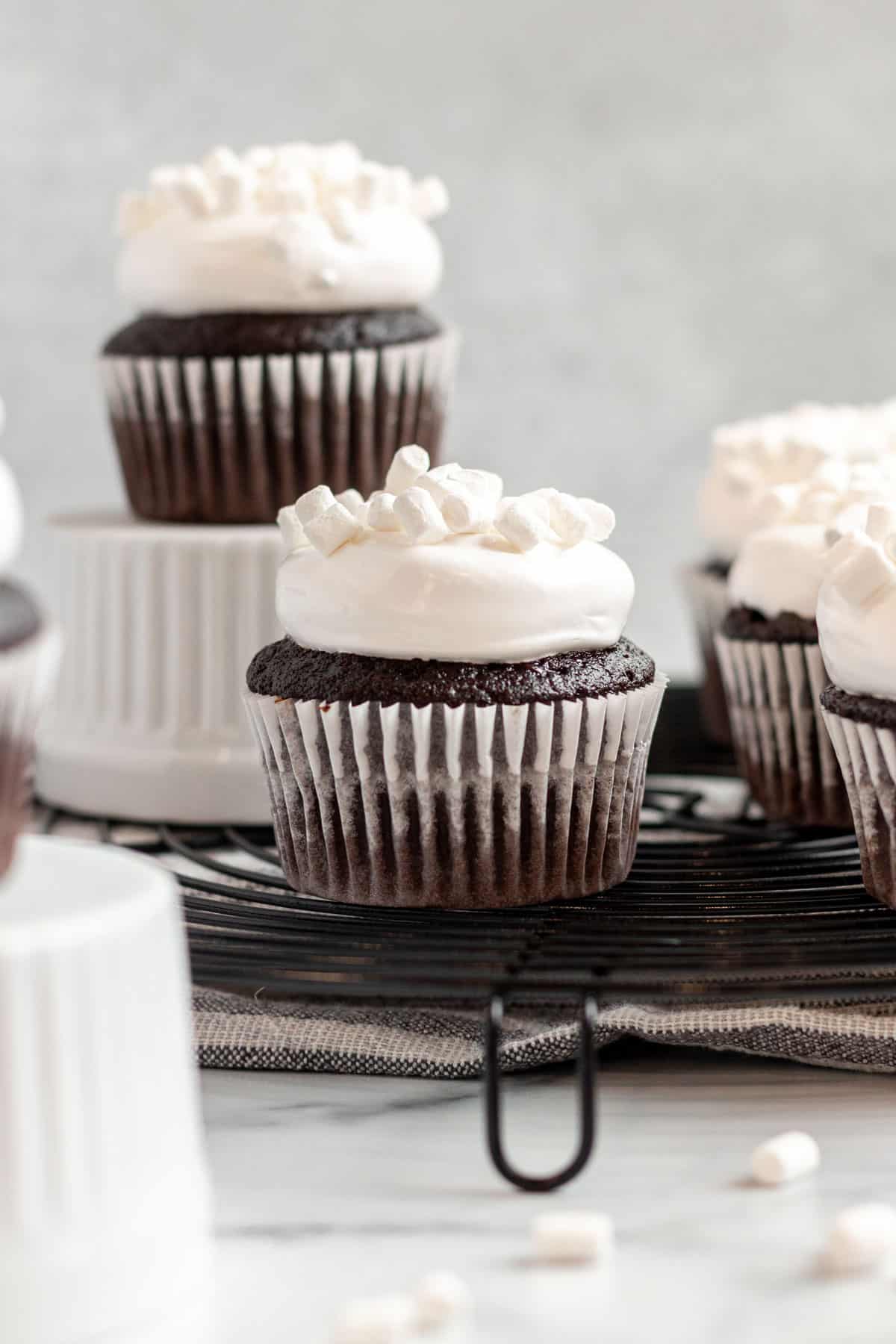 close up of a hot chocolate cupcake with marshmallow frosting