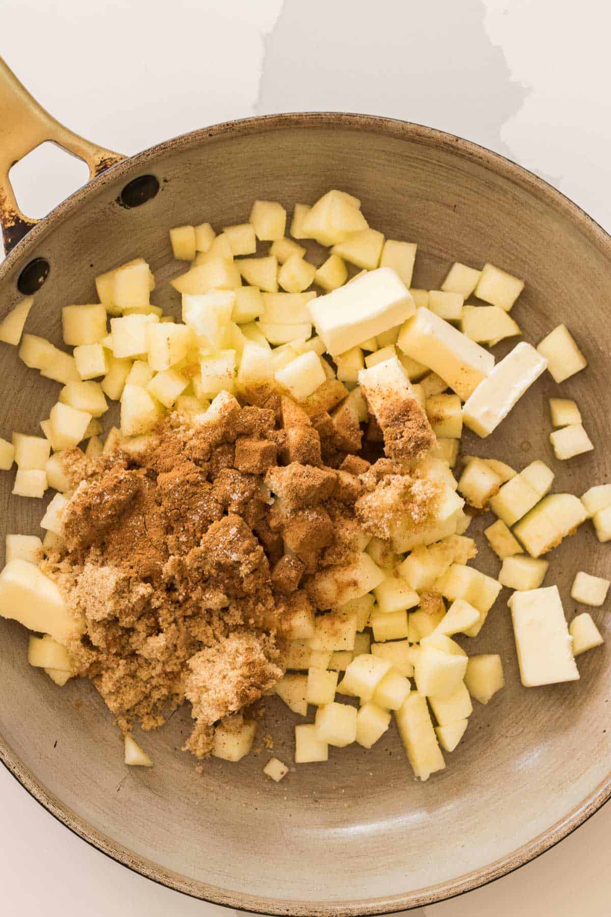 diced apples with butter, brown sugar and cinnamon in a saute pan